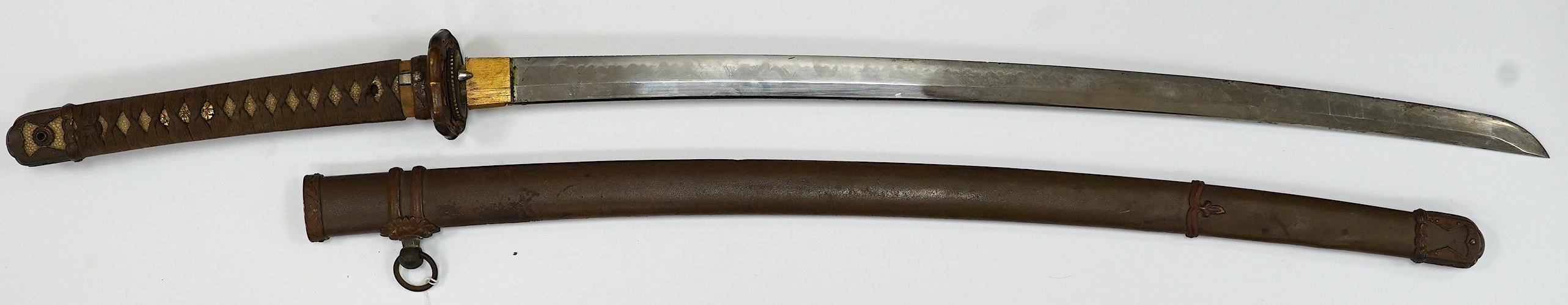 A Japanese WWII army officer’s sword Katana, blade 65cm, signed tang, retaining good polish, in shin gunto mounts. Condition - good